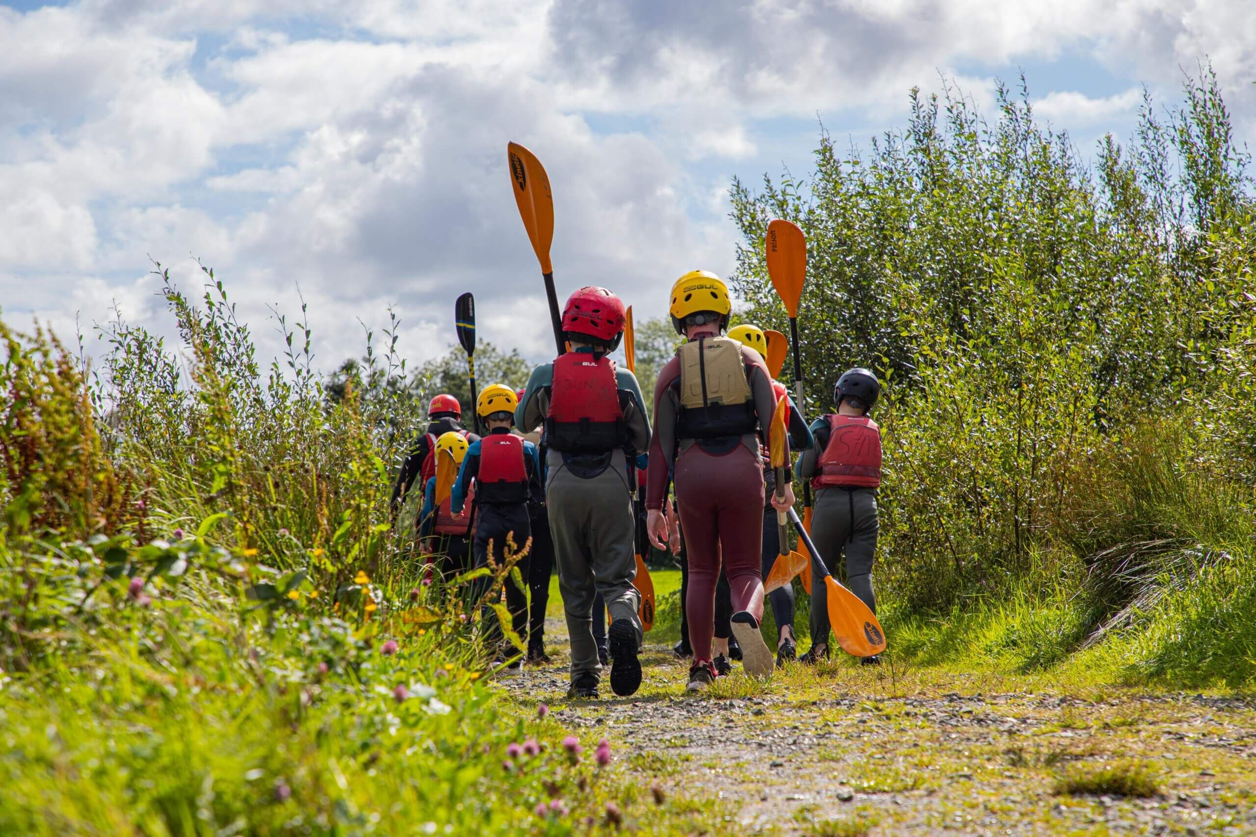 Kids walking to launch their SUP boards