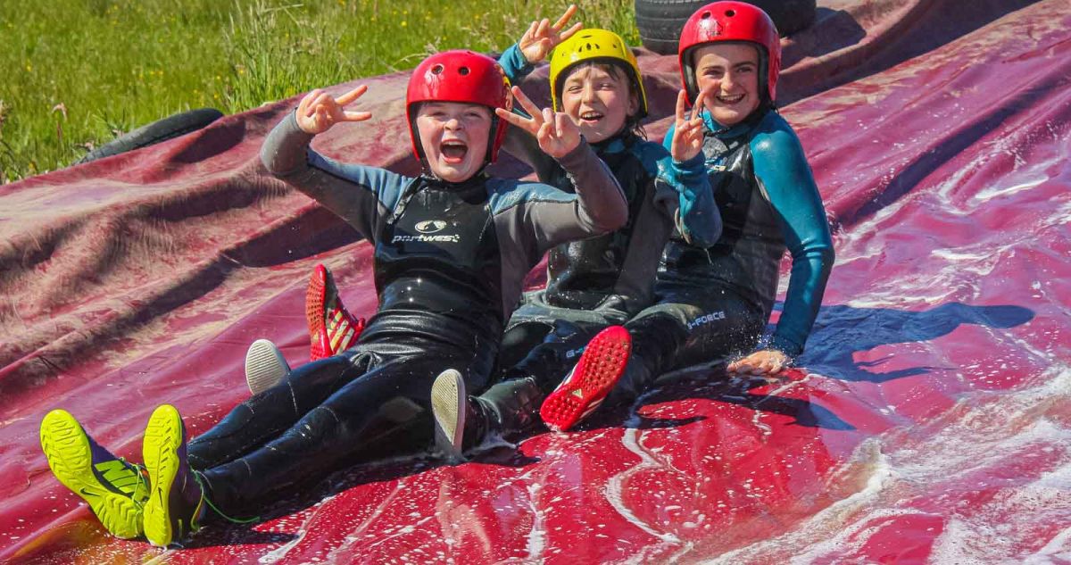 3 girls sliding down together